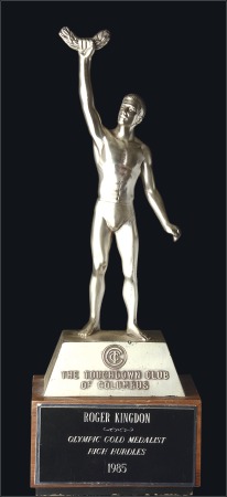 Stamp of Olympics Statues: Athlete in metal holding up an Olympic wi