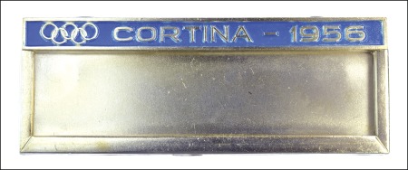 Stamp of Olympics 1956 Cortina official name badge with Olympic ring