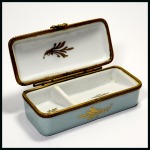 Stamp of Stamp Boxes Miscellaneous Materials: Handpainted porcelain stamp box with two sliding compartments, with gilt and coloured floral border on the lid