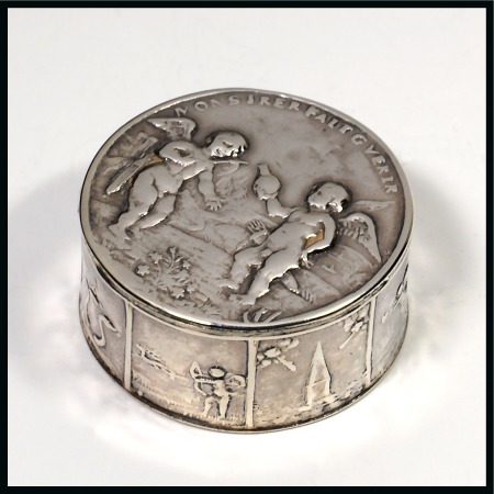 Stamp of Stamp Boxes White metal pill box with embossed lid showing two cherubs