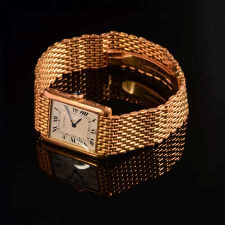 Stamp of Feldman International Auctions » Montres / Watches CARTIER. Montre mécanique en or jaune 750.