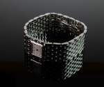 Stamp of Feldman International Auctions » Montres / Watches CARTIER "Panthère" manchette ruban en or blanc 18K