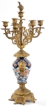 Stamp of Feldman International Auctions » Mobilier, Objets d'Art & Design / Furniture, Objets d'Art & Design Garniture de cheminée dans le style du XVIIIème siècle comprenant une pendule et deux candélabres, associés à des vases Imari. XIXème siècle